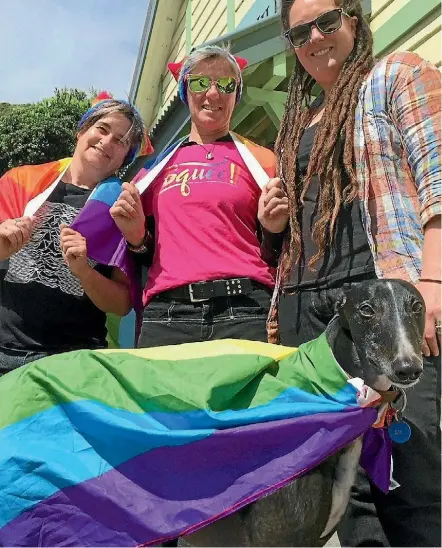  ?? ROSS GIBLIN/FAIRFAX NZ JOEL MAXWELL ?? Pride in Paeka¯ka¯riki organisers Pat McIntosh, Val Little, and Danielle Burns, with Bucko the ‘‘gayhound’’ outside the town’s St Peter’s Hall, which will be the end (and virtual beginning) of the Pride Parade.