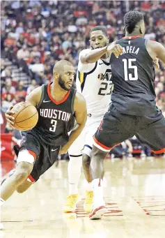  ?? — AFP photo ?? Chris Paul of the Houston Rockets drives past Royce O’Neale of the Utah Jazz as he receives a pick from Clint Capela during Game Five of the Western Conference Semifinals of the 2018 NBA Playoffs at Toyota Center in Houston,Texas.