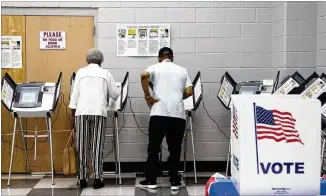  ?? REANN HUBER / REANN.HUBER@AJC.COM ?? People cast their vote during early voting at the C.T. Martin Natatorium and Recreation Center in Atlanta on Saturday.