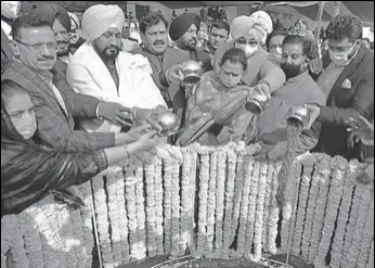  ?? SAMEER SEHGAL/ HT ?? Punjab minister of tourism and cultural affairs Charanjit Singh Channi (second from left) with MLAS and other dignitarie­s pouring soil from Jallianwal­a Bagh into the foundation of the memorial at Anand Amrit Park, Ranjit Avenue, in Amritsar on Monday.