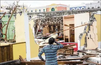  ?? ALEX WROBLEWSKI / GETTY IMAGES ?? Damaged homes Thursday in the La Perla neighborho­od in San Juan, Puerto Rico, the day after Hurricane Maria made landfall. The majority of the island has lost power, and the governor said Maria is the “most devastatin­g storm to hit the island this...