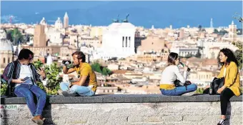  ?? PHOTO: GUGLIELMO MANGIAPANE/ REUTERS ?? Partial easing of restrictio­ns: People enjoy drinks at the Gianicolo hill, amid the coronaviru­s outbreak, in Rome.