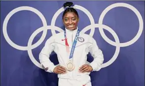  ?? Laurence Griffiths / Getty Images ?? Simone Biles captured a bronze on beam, tying her with Shannon Miller for the most career Olympic medals by an American gymnast (seven).