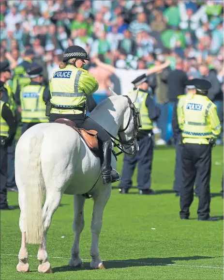  ??  ?? UNDER CONTROL: HIbernian supporters are sent back towards their area of the ground but the length of time it took police to restore order has been heavily criticised in the aftermath of Saturday’s Scottish Cup final.