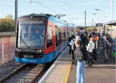  ?? MIKE HADDON. ?? The UK’s first ever public timetabled tram-train service, operated by 399203, arrives at Rotherham Parkgate on October 25 with the inaugural 0939 from Sheffield Cathedral.