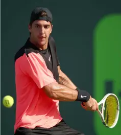  ?? — AFP photo ?? Thanasi Kokkinakis of Australia in action against Roger Federer of Switzerlan­d in their second round match during the Miami Open Presented by Itau at Crandon Park Tennis Centre in Key Biscayne, Florida.