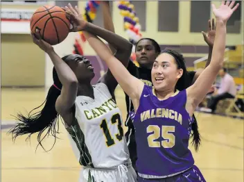  ?? Dan Watson/For The Signal (See additional photos on signalscv.com) ?? Canyon’s Selasi Mawugbe (13) and Valencia’s Chyanna Pagkalinaw­an (25) fight for the ball during the girls game of the SCV Hoops Finale on Saturday. The annual event was sponsored by The Signal.