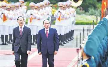  ??  ?? Sisi and Quang (left) review an honour guard during a welcoming ceremony at the presidenti­al palace in Hanoi. — AFP photo