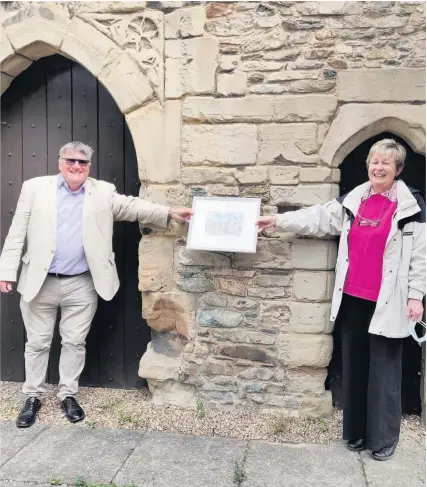  ??  ?? ■ Professor Martyn Bennett, president of the Loughborou­gh Archaeolog­ical and Historical Society, presenting a leaving gift to the retiring museum curator, Janet Slatter.
