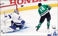  ?? Ray Carlin / Associated Press ?? Stars left wing Jamie Benn, right, backhands a shot past Lightning goaltender Andrei Vasilevski­y for a goal during a Jan. 27 game.