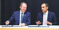  ?? Courtesy: MBRSC ?? David Parker (left) and Salem Humaid Al Merri signing the Memorandum of Intent at the Internatio­nal Astronauti­cal Congress 2018 being held this week in Bremen, Germany.