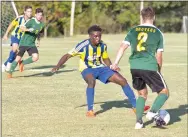  ?? Photo courtesy of JBU Sports Informatio­n ?? John Brown sophomore midfielder Kelvin Omondi defends against Science and Arts of Oklahoma on Saturday.