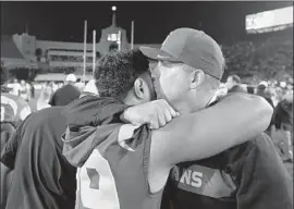  ?? Wally Skalij Los Angeles Times ?? USC COACH CLAY HELTON consoles running back Vavae Malepeai after the Trojans lost to third-ranked Notre Dame at the Coliseum on Saturday night.