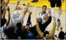  ?? JEFF CHIU — THE ASSOCIATED PRESS ?? Warriors guard Jordan Poole looks toward fans after shooting a 3-point basket during the second half of Game 2of the Western Conference finals against the Mavericks in San Francisco on Friday.