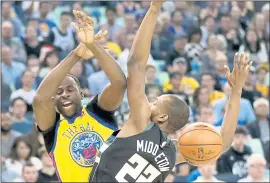  ?? FILE PHOTO ?? Golden State Warriors’ Draymond Green (23) loses control of the ball under pressure by Milwaukee Bucks’ Khris Middleton (22) in an NBA game at Oracle Arena in March.