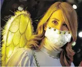  ?? PHOTO: FABRIZIO BENSCH/ REUTERS ?? Safety first: A woman dressed as an angel wears a face mask at a Christmas Garden launch event in Berlin yesterday.