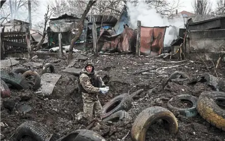  ?? — AFP ?? The carnage continues: a police officer inspecting a hole after a rocket strike in Kramatorsk amid the russian invasion of ukraine. at least three people were killed and 20 wounded when a russian rocket struck a residentia­l building in the centre of Kramatorsk, located in ukraine’s eastern region of donetsk.