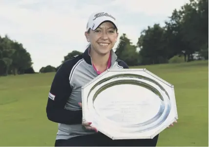  ??  ?? 0 Heather Macrae with her WPGA Championsh­ip trophy. She is aiming to play in Texas following her surgery.