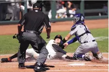  ?? JED JACOBSOHN/ASSOCIATED PRESS ?? Colorado catcher Tony Wolters, right, tags out the Giants’ Wilmer Flores trying to score in the second inning of their game in San Francisco on Thursday.