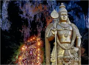  ?? Photo: REUTERS ?? Hindu devotees climb the steps to Batu Caves temple during Thaipusam in Kuala Lumpur. Piercing various parts of their body with silver skewers, devotees carry contraptio­ns known as kavadi, frameworks which are strapped to the back with hooks that...