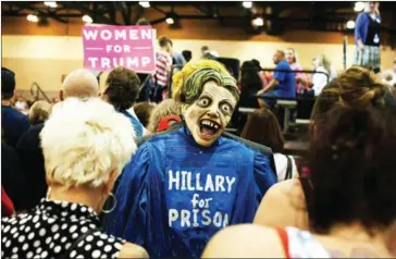  ?? CAITLIN O’HARA/AFP ?? Trump supporter dressed as Hillary Clinton as a zombie on his back attends Republican presidenti­al nominee Donald Trump rally at the Convention Center in Phoenix, Arizona, on Saturday.