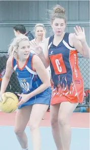  ??  ?? Bunyip’s Hannah Whyte moves the ball quickly against Koo Wee Rup’s Nikita Stokkel. Photograph­s by Michael Robinson.