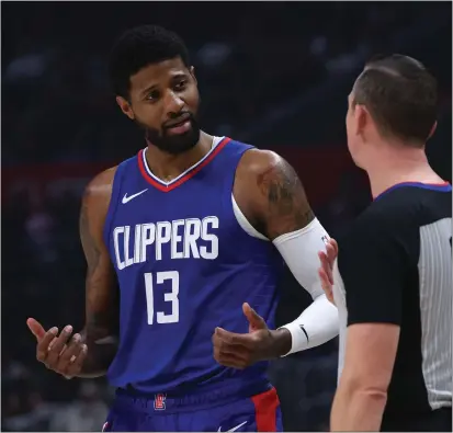  ?? HARRY HOW — GETTY IMAGES ?? The Clippers’ Paul George argues with referee Justin Van Duyne during Tuesday’s game against the Timberwolv­es at Crypto.com Arena.