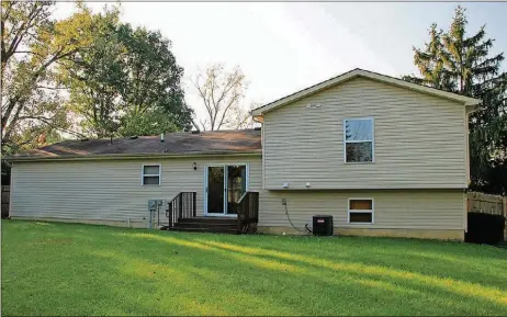  ??  ?? Patio doors off the dining room open to a deck and the backyard surrounded by a corral fence.