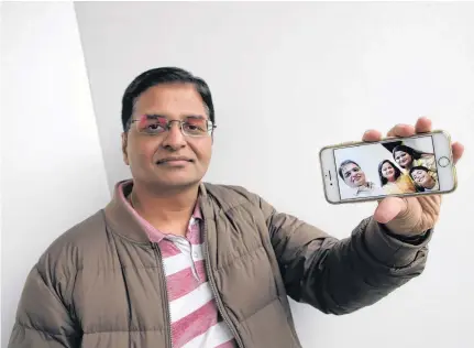  ?? TIM KROCHAK • THE CHRONICLE HERALD ?? Gaurav Sadh of Halifax displays a family photo of himself, his wife Sakshi, daughter Krisha and son Vivaan, taken last October. His family has been left stranded in India since March because of the COVID-19 pandemic.