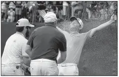  ?? AP/THEMBA HADEBE ?? Branden Grace is sprayed with champagne Sunday after winning the Nedbank Golf Challenge by one stroke over Scott Jamieson in Sun City, South Africa.
