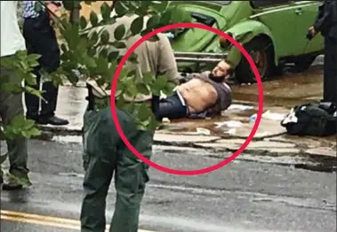  ??  ?? Surrounded: Ahmad Rahami, circled, lies in the street after yesterday’s shootout