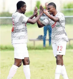  ?? GLADSTONE TAYLOR/ PHOTOGRAPH­ER ?? Patrick Brown (right) of UWI FC celebrates a goal with teammate Girvon Brown during their recent Red Stripe Premier League match against Montego Bay United. The match ended 1-1.