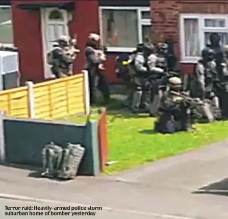  ??  ?? Terror raid: Heavily-armed police storm suburban home of bomber yesterday