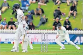  ?? AP ?? Virat Kohli (left) looks back as he is caught out by New Zealand's Ross Taylor off Kyle Jamieson. n