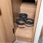  ??  ?? A slender cupboard located near the oven features holders for three bottles of wine