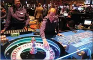  ?? WAYNE PARRY — THE ASSOCIATED PRESS ?? Dealers carry out a game of roulette at the Ocean Casino Resort in Atlantic City N.J. In a lawsuit filed last week, Atlantic City’s top casino, the Borgata, accuses Ocean Casino Resort of poaching its top marketing executives.