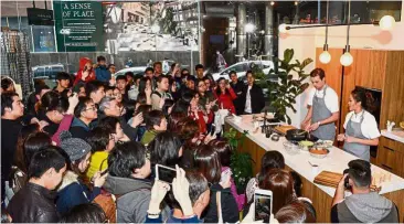  ??  ?? Tantalisin­g the tastebuds: Chan and her prep chef Sam Hocking enthrallin­g guests with a live cooking demo at the # AnakAnakMa­laysia ‘ Taste of Malaysia’ event in Melbourne.
