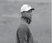  ?? PHOTO/JEFF CHIU] ?? Tiger Woods stands on the putting green during practice for the PGA Championsh­ip golf tournament at TPC Harding Park in San Francisco on Tuesday. [AP