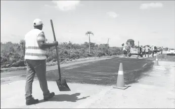  ??  ?? The Ministry of Communitie­s doing some patchwork at the western end of the road on Tuesday afternoon.