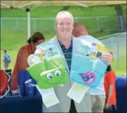  ??  ?? Cohoes Mayor Shawn Morse displays some of the U.S. Coast Guard approved puddle jumper life jackets that were given to children who attended the water safety education event at Lansing’s Pool Wednesday afternoon.