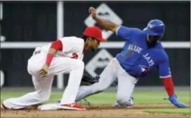  ?? MATT SLOCUM — THE ASSOCIATED PRESS ?? Utilityman Pedro Florimon, left, started in place of struggling Scott Kingery at shortstop for the Phillies Friday night. An errant Florimon throw helped the Blue Jays score three runs in the first inning, though that play was eventually ruled a hit...