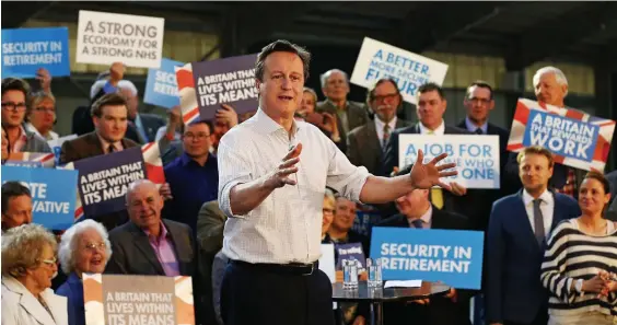  ??  ?? Pulling the wool over our eyes: Mr Cameron appears to address a placard-waving throng, but in reality the ‘rally’ hardly fills a corner of a barn