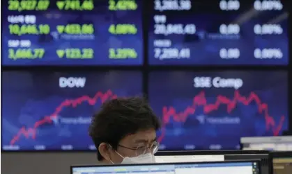  ?? ?? A trader at KEB Hana Bank in Seoul, South Korea on Friday when many Asian markets were in the red. Photograph: Ahn Young-joon/AP