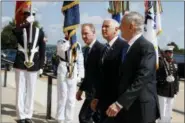  ?? EVAN VUCCI — THE ASSOCIATED PRESS ?? In this file photo, Vice President Mike Pence, center, is greeted by Deputy Secretary of Defense Pat Shanahan, left, and Secretary of Defense Jim Mattis before speaking at an event on the creation of a United States Space Force at the Pentagon. With his demand that the Pentagon create a new military service — a Space Force to assure “American dominance in space” — President Donald Trump has injected urgency into a long-meandering debate over the best way to protect U.S. interests in space, both military and commercial.