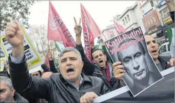  ?? PICTURE: EPA ?? RAGE: Turkish protesters shout slogans against Russia as they hold a picture of Russian President Vladimir Putin reading ‘murder on Putin’ during a protest against Russia after Friday prayers in Istanbul, Turkey, yesterday.