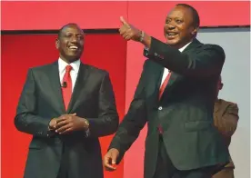  ??  ?? NAIROBI: In this file photo taken on June 26, 2017 shows Kenya’s President Uhuru Kenyatta (R), flanked by Deputy President William Ruto, gesturing during the unveiling of the Jubilee Party’s manifesto. — AFP