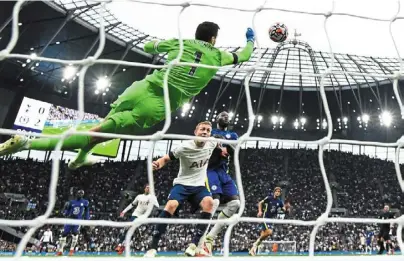  ?? — AFP ?? In safe hands: Tottenham goalkeeper Hugo Lloris punches the ball away during the match against Chelsea at Tottenham Hotspur stadium in London.