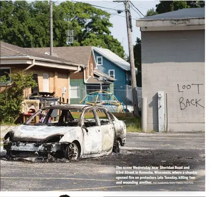  ?? PAT NABONG/SUN-TIMES PHOTOS ?? The scene Wednesday near Sheridan Road and 63rd Street in Kenosha, Wisconsin, where a shooter opened fire on protesters late Tuesday, killing two and wounding another.