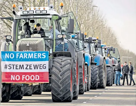  ?? ?? Tractors queue before a protest by farmers in the Zuiderpark, an area south of the city centre in The Hague, over government plans to cut nitrate emissions