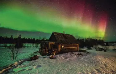  ??  ?? CLOCKWISE FROM LEFT The Northern Lights dance above a wooden hytte in the Arctic Circle; reindeer skins and outdoor cooking are part of the lifestyle in Skaidi, Norway; a typical Norwegian hytte is cosy and simply furnished